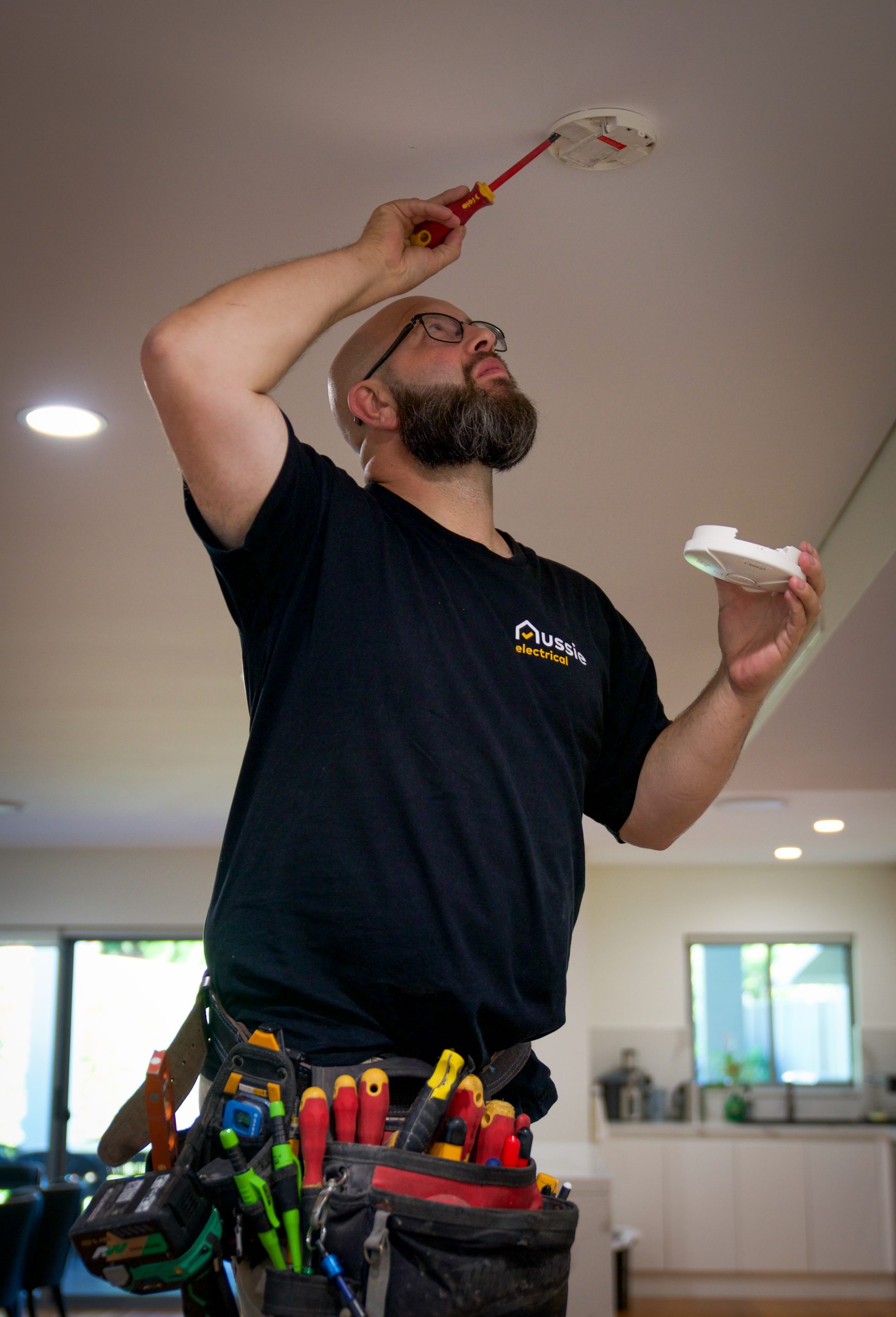 Aussie Electrical and Plumbing performing smoke alarm installation.