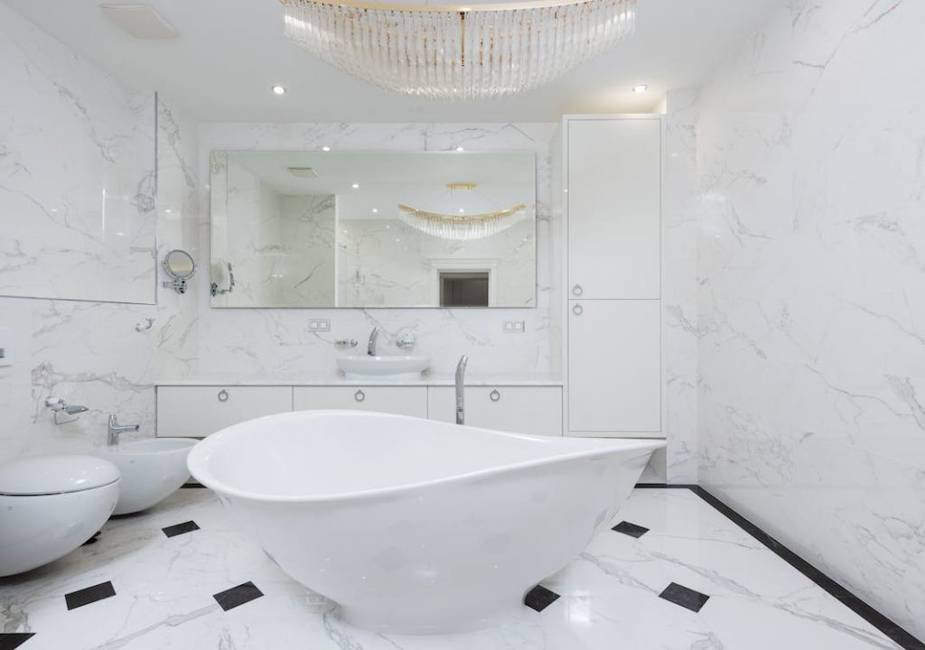 A bathroom with tiles that has diamond style.